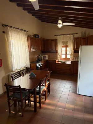 a kitchen with a table and chairs and a refrigerator at Omodos Village Houses in Omodos