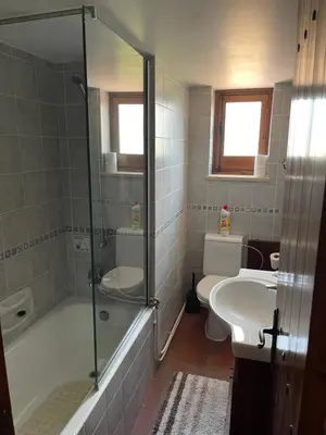 a bathroom with a shower and a toilet and a sink at Omodos Village Houses in Omodos