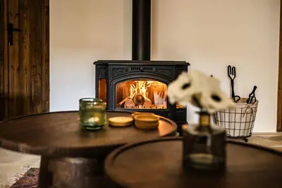 a table with a wood stove in a room at Eftychia's House in Lofou