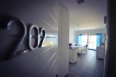 a room with a hallway with a room with a desk at Krasas Beach Apartment Rentals in Larnaka