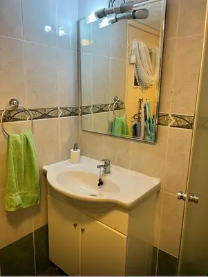 a bathroom with a sink and a mirror at Bar street apartment in Ayia Napa