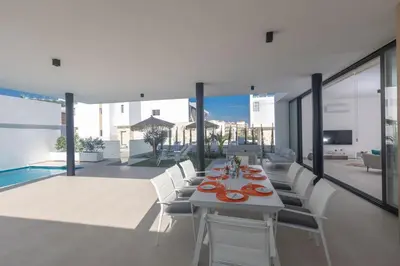 a dining room with a table and chairs on a patio at Protaras Aqua Pearl Villa in Protaras