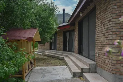 a brick building with a set of stairs next to a house at Orama Mountain Villa Farmakas in Nicosia