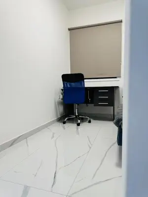 a blue chair sitting in front of a computer monitor at Brand new, Finikoudes area in Larnaka