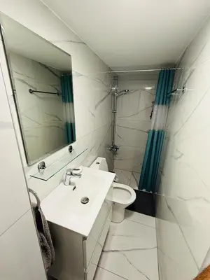a bathroom with a sink and a toilet and a mirror at Brand new, Finikoudes area in Larnaka