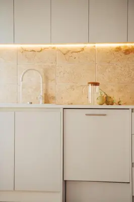 a kitchen with white cabinets and a sink at Hyperion Boutique Villa in Voroklini