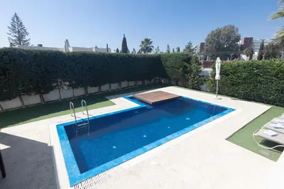 a swimming pool in the middle of a yard at Sea Satin Villas - Ayia Napa Center in Ayia Napa