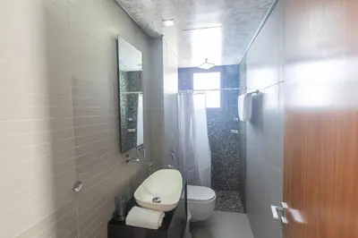 a white bathroom with a toilet and a shower at Sea Satin Villas - Ayia Napa Center in Ayia Napa