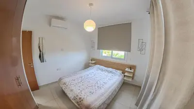 a room with a bed and a window in it at Hi royal villa in Pervolia