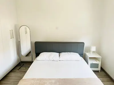 a bedroom with a large bed and a mirror at LimassolStar Etko Area in Limassol