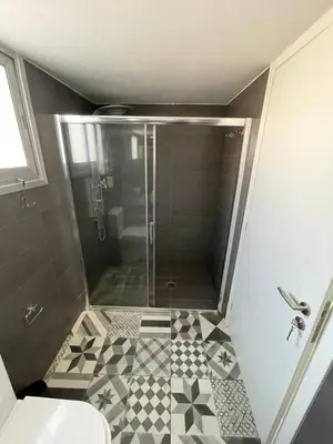 a shower with a glass door in a bathroom at LimassolStar Etko Area in Limassol