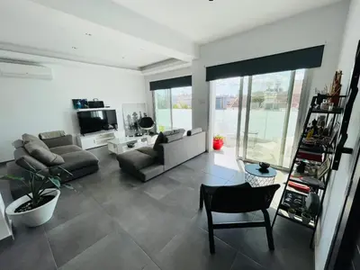 a living room with a couch and a chair at LimassolStar Etko Area in Limassol