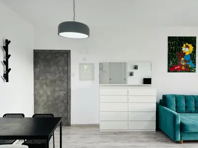 a living room with a blue couch and a table at White 1-bdr apartment Agyos Tychonas in Limassol