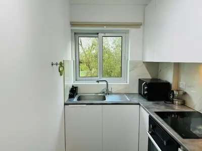 a kitchen with a sink and a window at White 1-bdr apartment Agyos Tychonas in Limassol