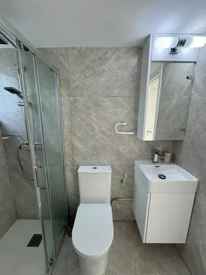 a bathroom with a toilet and a shower and a sink at White 1-bdr apartment Agyos Tychonas in Limassol