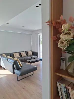 a living room with couches and a book shelf at Luxury Seafront 2 bedroom in Limassol