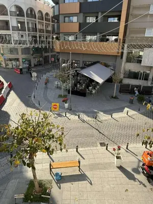 an empty courtyard with a bench and a building at D Pitsillos Homes luxury in Larnaka