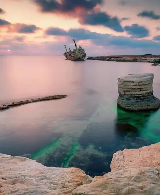 a ship in the middle of a body of water at Nissi Si Lux Boho Apartment on Nissi beach in Ayia Napa
