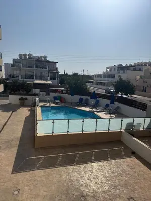 a swimming pool on the roof of a building at Kapparis Pleasure Familly Lounge in Paralimni