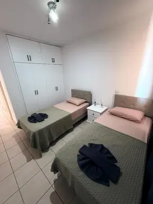 two beds sitting in a room withermottermott at Kapparis Pleasure Familly Lounge in Paralimni