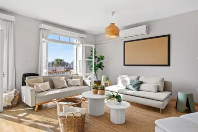 a living room with a couch and a table at St Lazar Penthouse Apartment in Larnaka
