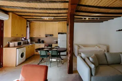 a kitchen and living room with a couch and a table at Rustic Elegance in Omodos in Omodos