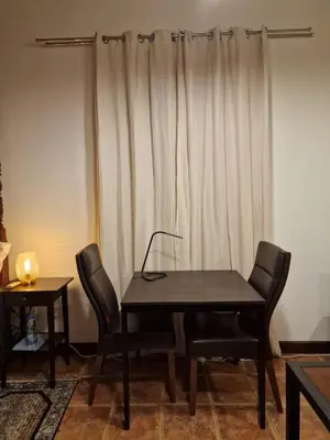 a table and chairs in a room with a curtain at The Courtyard Suite in Limassol