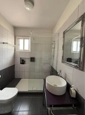 a bathroom with a tub and a sink and a toilet at Elegant 2BR Apartment- La Vie Royale in Nicosia
