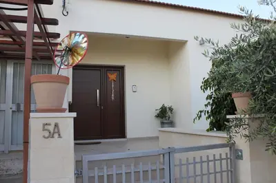 a front door of a house with a sign in front at Modern spotless house with full privacy and WiFi in Aglantzia Nicosia in Aglantzia
