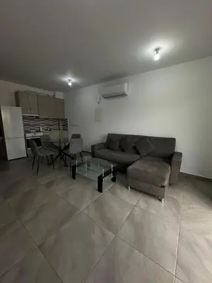 a living room with a couch and a table at Oroklini's Flat in Larnaka