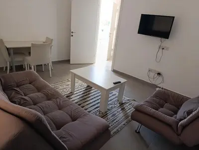 a living room with a couch and a table at FLAT Ceremi in Nicosia