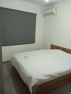 a bed in a room with a large window at FLAT Ceremi in Nicosia