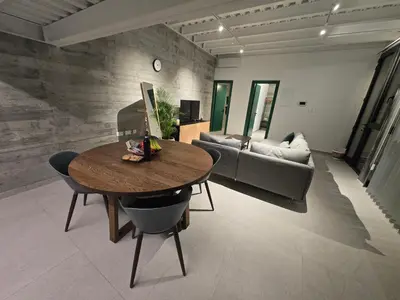 a living room with a table and a couch at Green Leaf - Old City Suite in Limassol