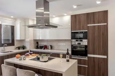a kitchen with a island with a counter top at Ayia Napa Seafront Ionion Villa H5 in Ayia Napa