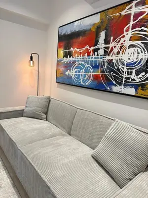 a living room with a couch and a painting on the wall at Aurora Downtown Living in Nicosia