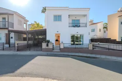 a white building with a fence in front of it at Villa Maria in Protaras