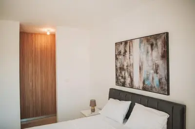 a bedroom with a bed and a painting on the wall at Jupiter Villa in Voroklini