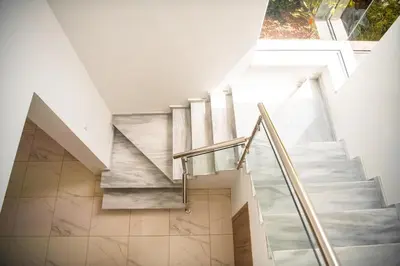a staircase in a house with a glass railing at Jupiter Villa in Voroklini