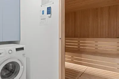 a washer and dryer in a bathroom next to a wall at Serenity Waves Villa 2 in Larnaka