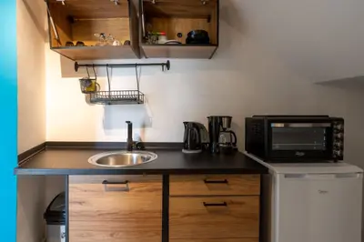 a small kitchen with a sink and a microwave at The Pop Art Residences & Studios in Larnaca in Larnaka