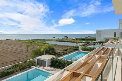 a view of the ocean from the balcony of a house at Serenity Waves Villa 8 in Sophtadhes