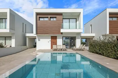a house with a swimming pool in front of it at Serenity Waves Villa 11 in Larnaka