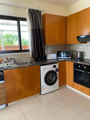 a kitchen with a washing machine and a sink at A sea breeze house in Larnaka