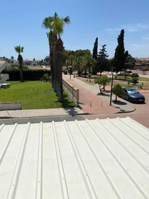 a view of a parking lot with a palm tree at A sea breeze house in Larnaka
