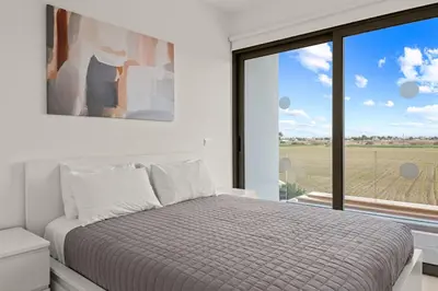 a bedroom with a bed and a large window at Serenity Waves Villa 20 in Larnaka