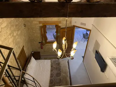 an overhead view of a room with a bed and a chandelier at Vouni Calais in Vouni