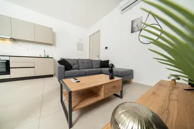 a living room with a couch and a table at 1 bedroom flat in Aglatzia in Aglantzia