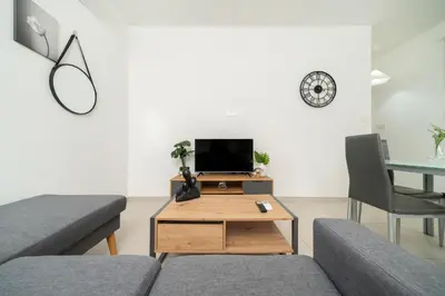 a living room with a couch and a table at 1 bedroom flat in Aglatzia in Aglantzia