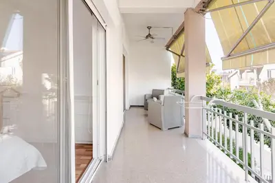 a balcony with white walls and a glass door at Central Escape in Limassol