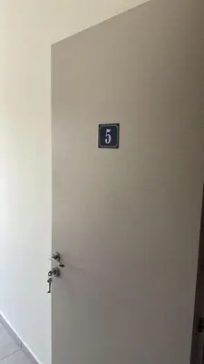 a room with a door with a number on the wall at Unique City Center Rooms, 150m from Chabad Lubavitch in Larnaka